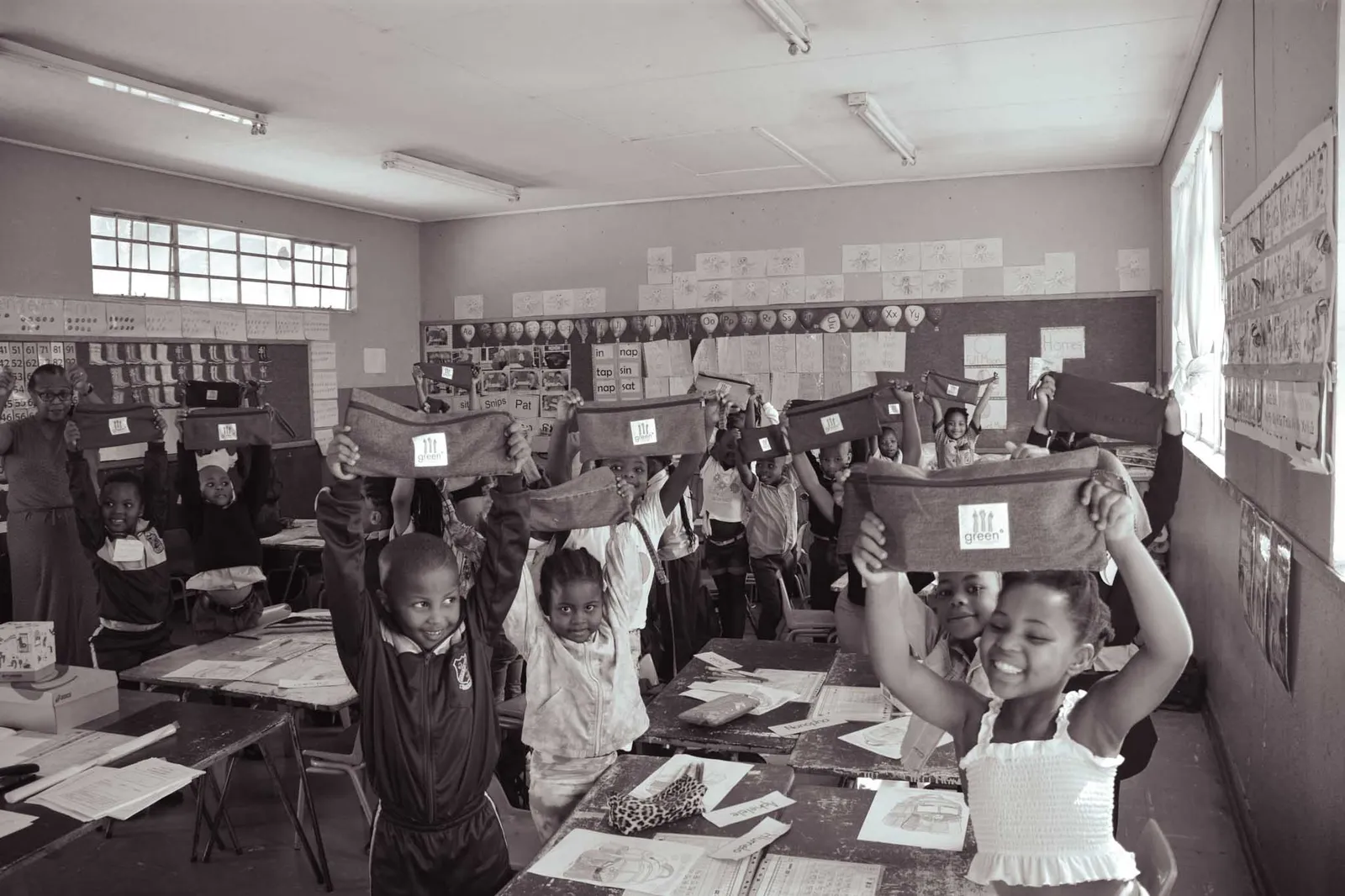 children at Capricorn Primary holding up their new green° denim pencil cases